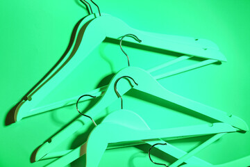 Toned clothes hangers on green background
