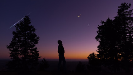 Man observing evening sky with stars, planets and crescent Moon.