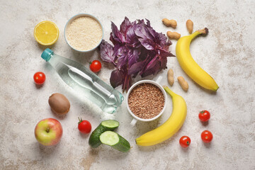 Set of healthy products and bottle of water on light background