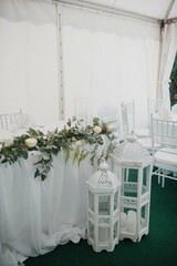Table setting at a luxury event and beautiful flowers on the table. Beautiful wedding arch of flowers.