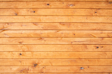 Fototapeta premium Modern log house block house wooden brown built abstract texture background. Wooden wall siding horizontal brown.
