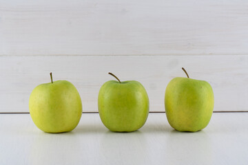 Green apple on white background, fruity concept, top view, copy space