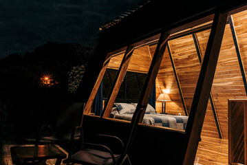 Fototapeta premium Interior of a cabin with interior lights on at night. 