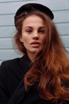 Portrait of a beautiful girl walking on the street in stylish clothes 