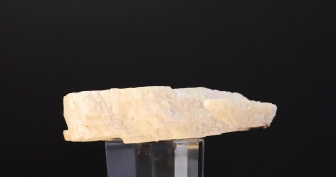 rotation of feldspar (perthite) mineral crystal on black background