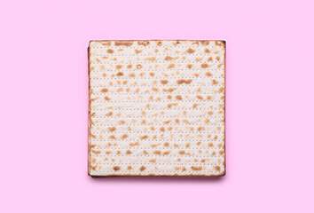 Jewish flatbread matza for Passover on pink background