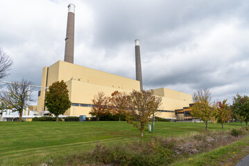 View of a gas-fired power plant with two tall smokestacks on a cloudy autumn day