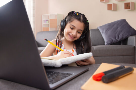 Girl studying online using laptop at home