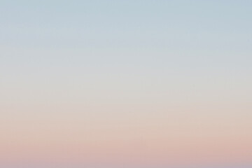 Faded clear sky at evening dusk. Pastel colour gradient background