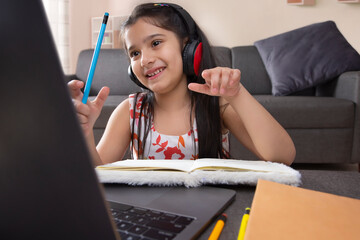 Girl studying online using laptop at home