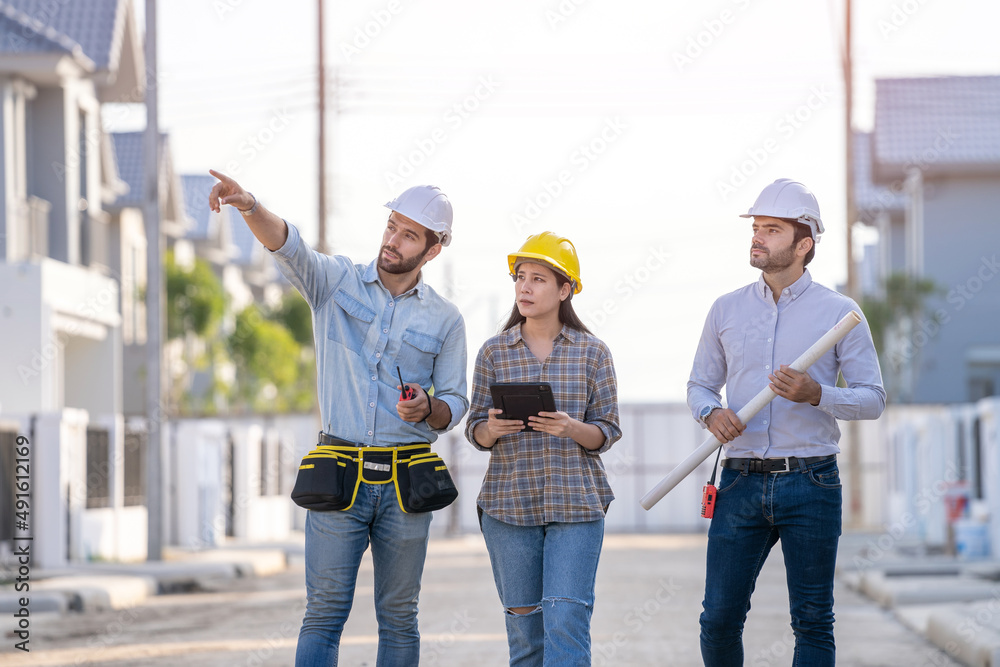 Poster engineer working on construction building site,architects discussing project of building outdoors.