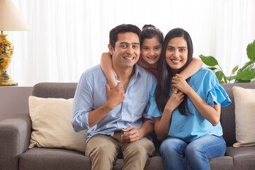 Happy couple with their little daughter at Home