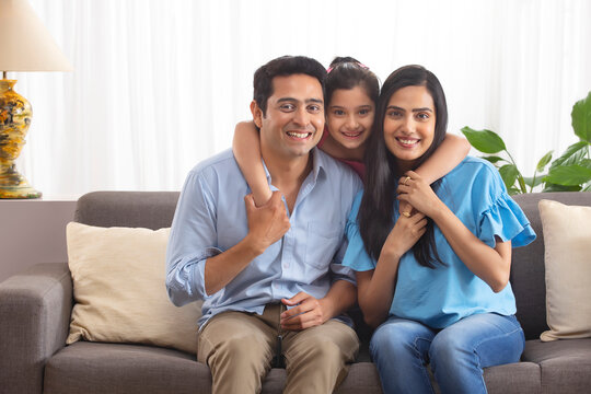 Happy couple with their little daughter at Home