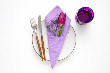 Simple table setting with flowers on white background