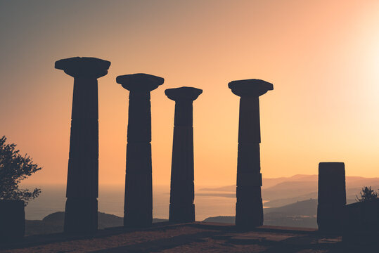 Doric column ruins of the Temple of Athena at sunset. Assos Ancient City. Behramkale, Canakkale, Turkey