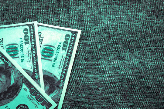 Fake hundred-dollar bills with green tinting and copy space. Bribe In large quantities with counterfeit banknotes.