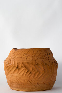 Vertical photo of clay pot and copy space. Clay pot with pattern and copy space.