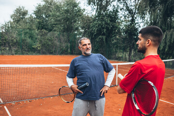 friends playing tennis outdoor on clay court