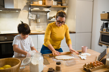 mother and son enjoying time preparing food in kitchen