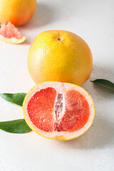 Delicious grapefruits on light background