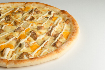 Pizza with chicken, mayonnaise sauce and cheese, on a white background