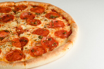 Pizza with pepperoni, jalapeno pepper and cheese, on a white background