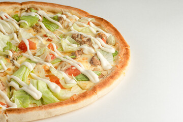 Pizza with chicken, lettuce, tomato, mayonnaise sauce and cheese on a white background