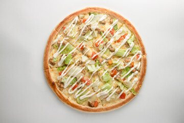 Pizza with chicken, lettuce, tomato, mayonnaise sauce and cheese on a white background