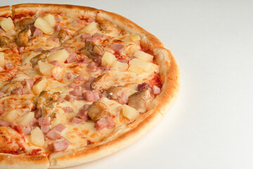 Pizza with pineapple, ham, meat and cheese on a white background