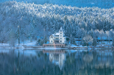 The Grundlsee, the largest lake in Styria. On the shore is the majestic Villa Castiglioni. Austrian mountain landscape, on a foggy winter morning. Ausserland, Styria, Austria