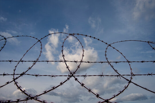 Razor wire fence, with blue sky background