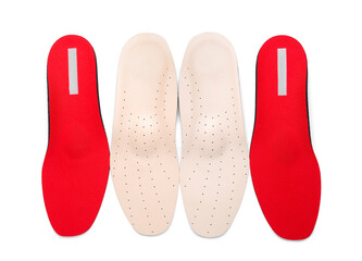 Two pairs of orthopedic insoles on white background