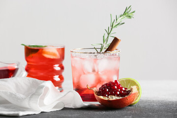 Glasses of tasty pomegranate cocktail on table