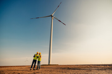 Male workers at electricity site. Windmill field