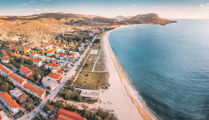 Visit Toroni beach of Greece. Aerial view of the idyllic seascape on the Sithonia peninsula in Halkidiki. High above the roofs of the resort village with villas and hotels.