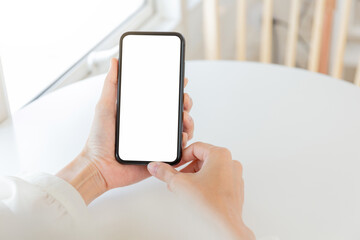 cell phone blank white screen mockup.hand holding texting using mobile on desk at office.background empty space for advertise.work people contact marketing business,technology