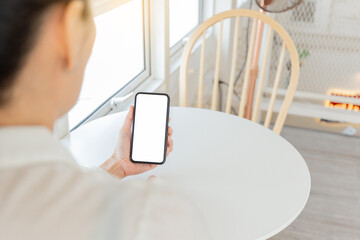 cell phone blank white screen mockup.hand holding texting using mobile on desk at office.background empty space for advertise.work people contact marketing business,technology