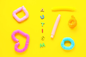 Word AUTISM with Pop Tubes on yellow background