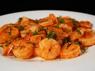 Fried king prawns on a white plate, close-up