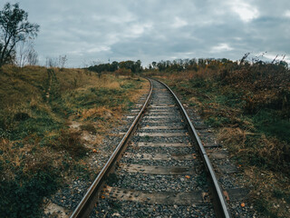 Fototapeta na wymiar Railway track turn. Iron train rails in the countryside.