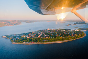 Aerial view of the island-town of Sviyazhsk. A historical landmark of Russia and the Republic of Tatarstan. Sviyaga and Volga river. The island is round in shape. Churches and residential buildings.