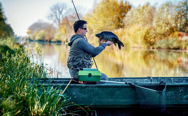 Carp fishing. Fisherman angling on the river. Sport and recreation concept