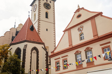 Obraz premium Tabor, South Bohemia, Czech Republic, 29 August 2021: Clock bell tower of gothic Church of Transfiguration on Mount on main Square of Jan Zizka near town hall, cityscape of medieval town, summer day