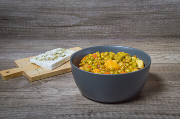 Fresh green peas with tomato sauce potatoes and carrot Greek food