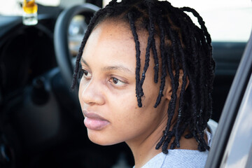Fototapeta na wymiar Black African Woman sitting in a car