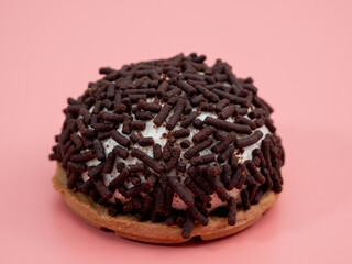 cake with chocolate chips on a pink background.