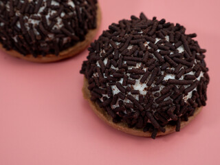 cake with chocolate chips on a pink background.