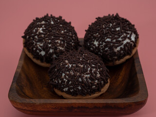 cake with chocolate chips on a pink background.