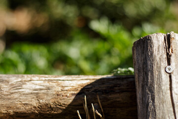 Wooden poles fence the sidewalk.