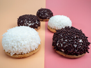 cake with coconut and chocolate chips on a pink and orange background.